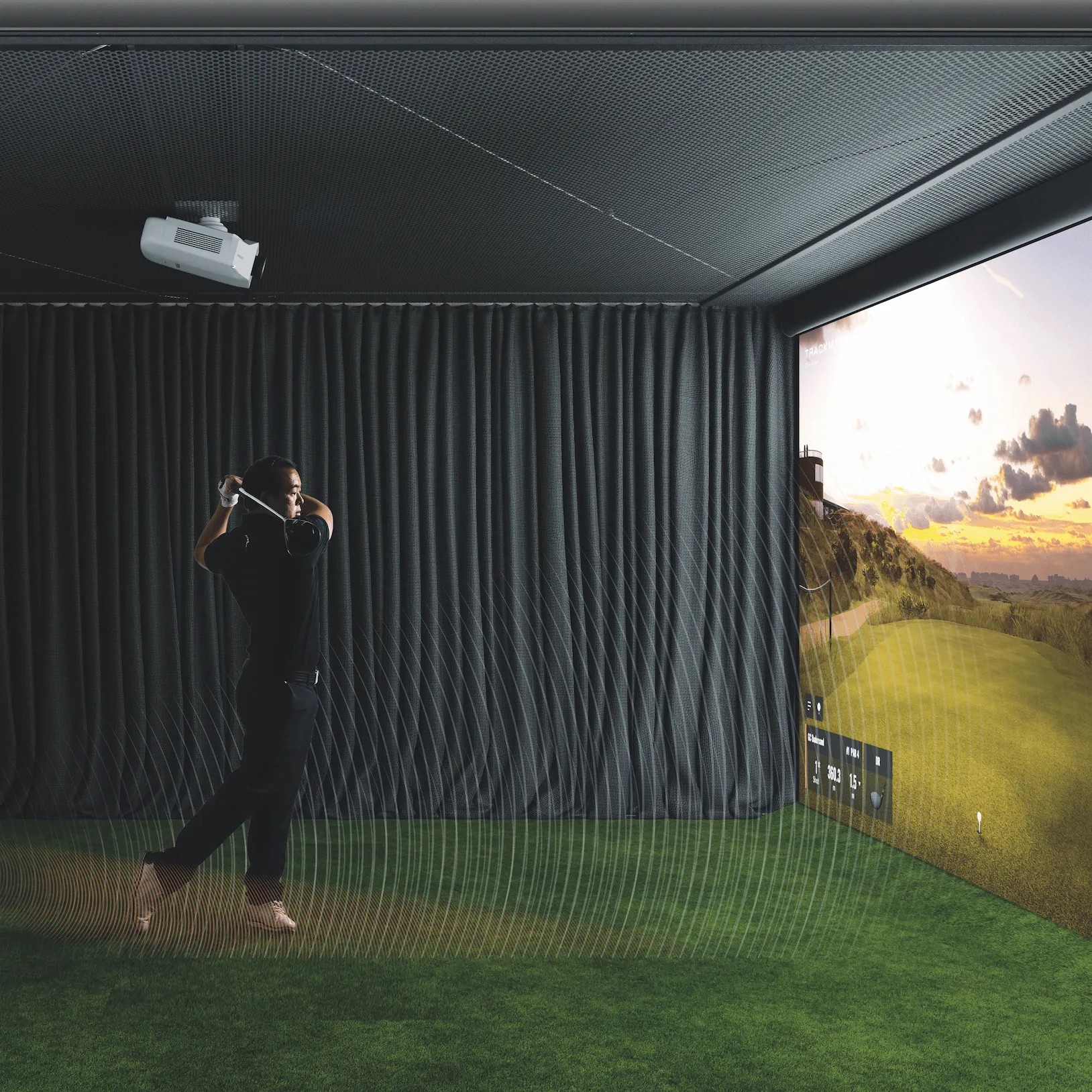 Simulator bay with golfer mid-swing